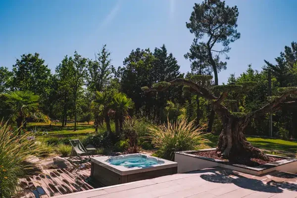 Création d'espaces bien-être avec spa et piscine - Rokaï Paysagiste Intégration d'un spa encastré et d'une piscine moderne dans un jardin paysager en Vendée par Rokaï